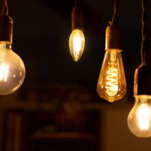 Retro LED light bulbs hanging on a dark background in interior. Electricity, Vintage