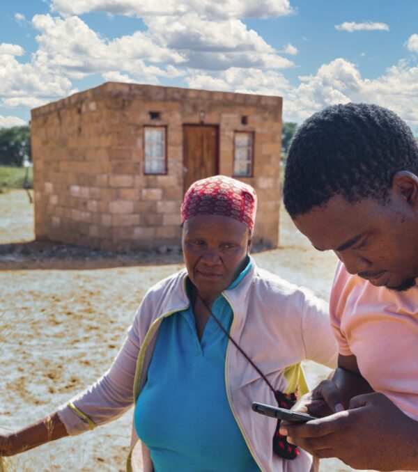 African,Village,,Old,Woman,Opening,In,Front,Of,The,House