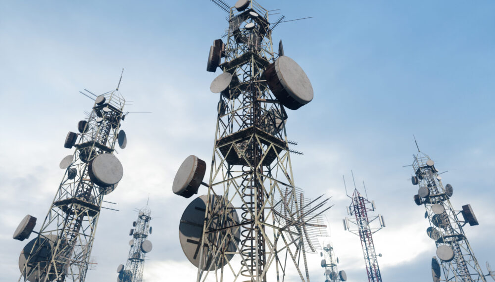 Close-up View Of Antenna Towers With Blue Sky Background